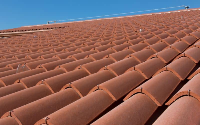 A clay tile roof with metal fasteners.