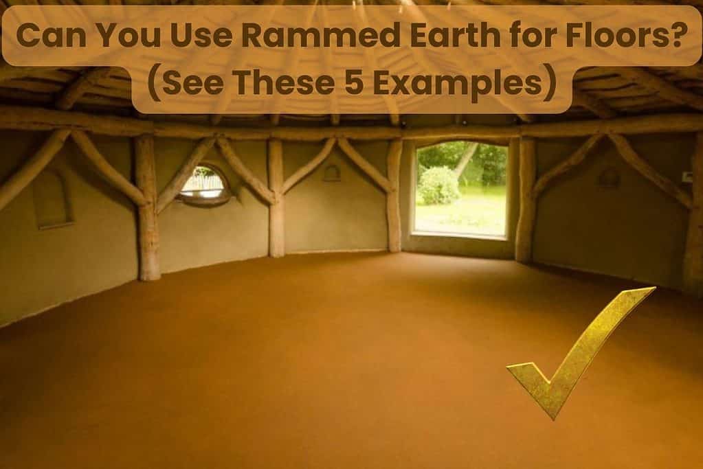 A round hut viewed from the inside. There are lots of exposed timbers around the outside of the wall and the earthen floor is a great example of a natural brown rammed earth floor. Across the top is written "Can You Use Rammed Earth for Floors? (See These 5 Examples)"