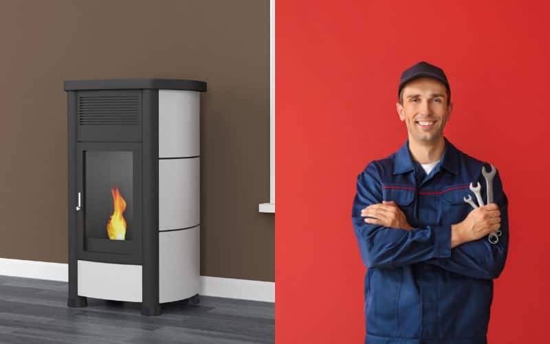 A corn pellet stove next to a heating engineer wearing overalls and holding a set of wrenches with a red wall in the background.