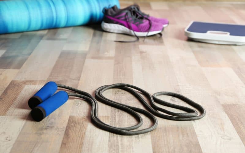 A hemp wood floor with exercise equipment on it to indicate the fact that it is hard wearing.