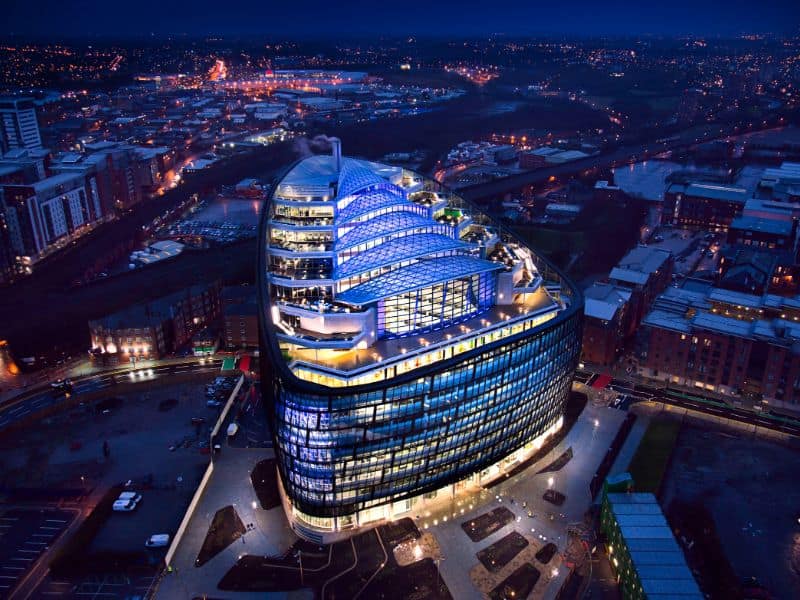 A picture of One Angel Square, Manchester taken at night.