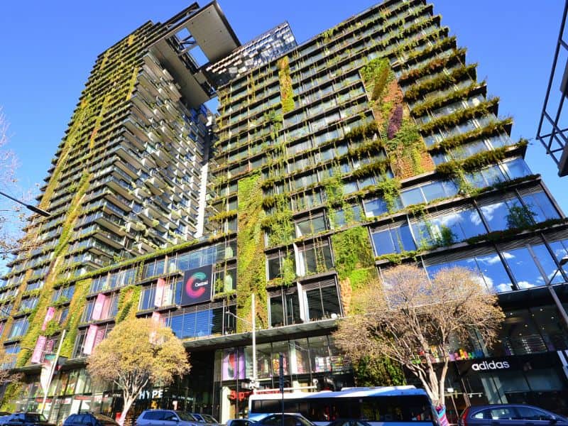 A photograph of One Central Park in Sydney, Australia. It's a high-rise building with lots of greenery on its facade.