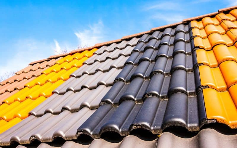 Rows of different colored solar tiles installed on a roof.