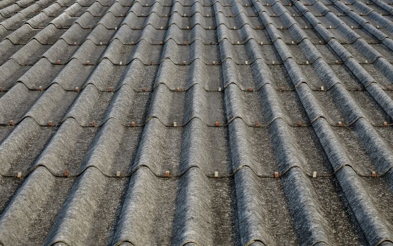 A roof made from concrete tiles with metal fixings.