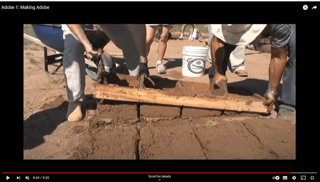 Video thumbnail of people removing a wooden mold from adobe bricks.