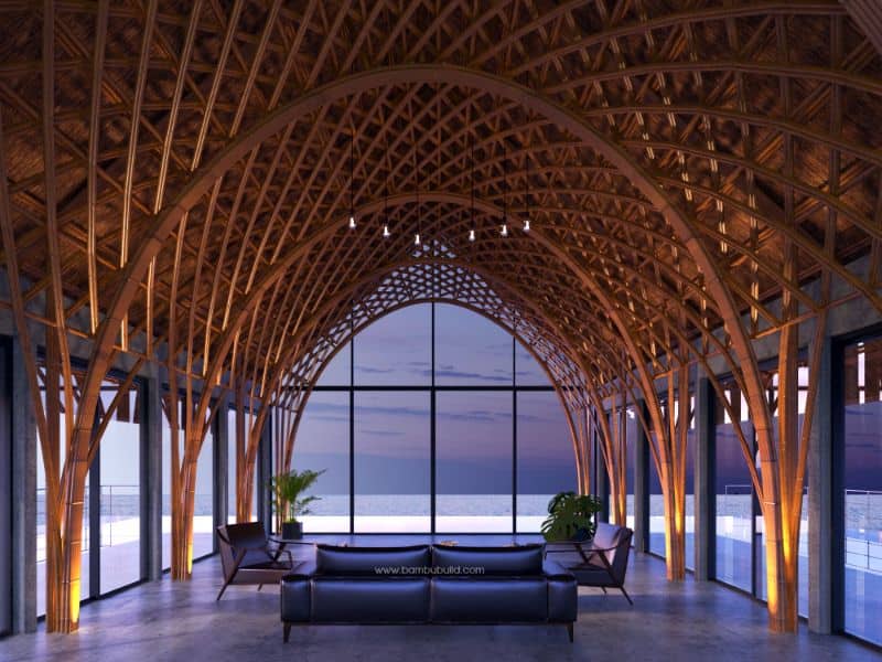 Bamboo overwater house, Doha, Qatar. The structure comprises a series of arches that support the roof. The structural members are beautifully designed and make for a stylish feature. The sides of the structure are glazed all the way around affording fabulous views of the ocean. The room is minimally furnished with three leather sofas in the center, and a potted plant in each corner.