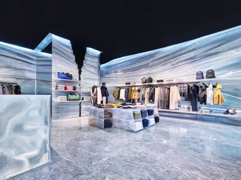 A futuristic shop design made with 3D printed plastic. The walls, floor and shelves have the appearance of ice and have naturalistic sweeping patterns.