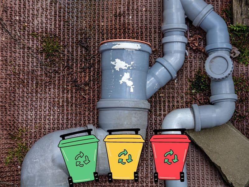 Plastic pipework laid out on the ground. There are cartoon recycling bins along the bottom of the image - a green bin, a yellow bin and a red bin. All three have green recycling arrows on their sides.