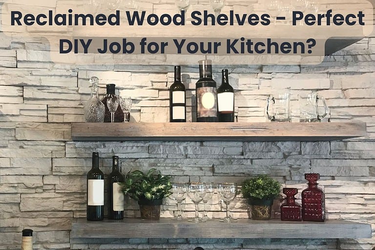 Three reclaimed wood shelves mounted on a stone wall in a kitchen with wine glasses and bottles arranged on them. Across the top are the words, "Reclaimed Wood Shelves - Perfect DIY Job for Your Kitchen?"