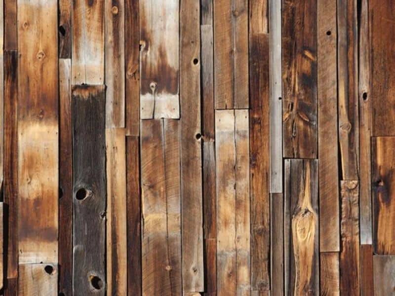 A closeup of slats of reclaimed wood flooring.