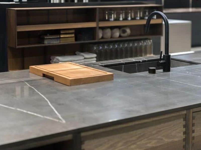 A Soapstone countertop with a scratch on the island in a kitchen.