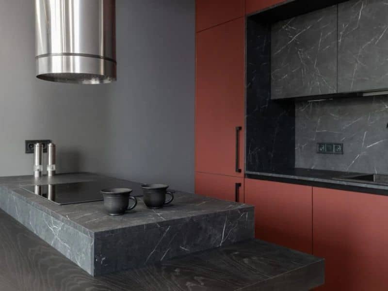 A kitchen that utilizes slate countertops and vertical surfaces.