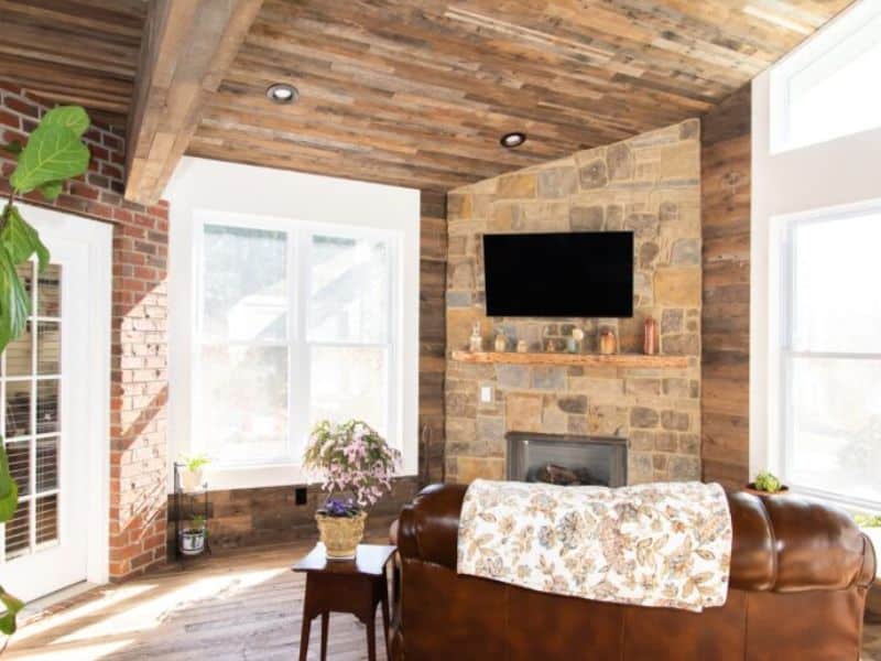 A reclaimed wood ceiling made from hemlock wood.  The colors in the ceiling complement the stone in the wall above the fireplace beautifully.