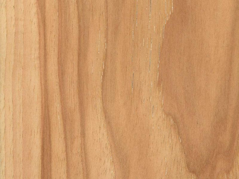 A closeup photo of hickory lumber such as that used to make hickory countertops. The wood is light brown and has a wavy grain pattern.