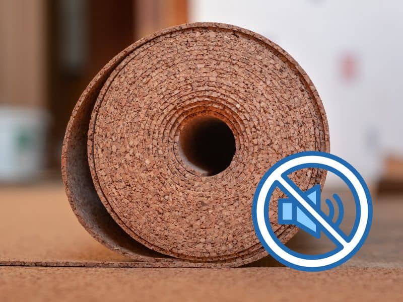 A roll of cork flooring is being installed on a subfloor. A blue loudspeaker icon with a circle with a line through it is in the bottom right.