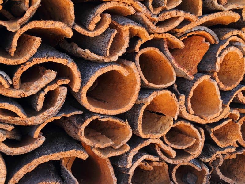 A stack of harvested oak cork tree barks curing in the open air.