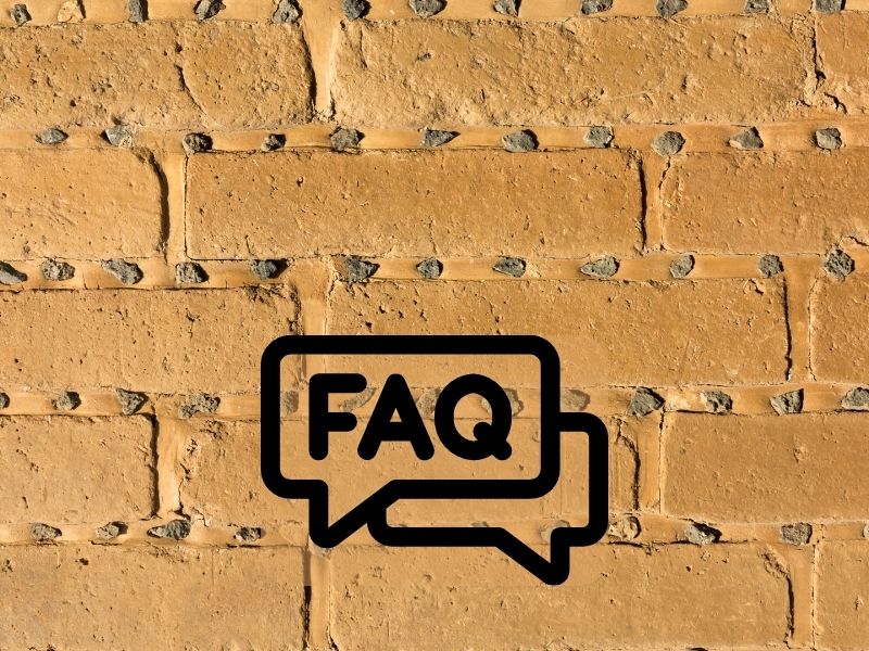 An adobe wall with FAQ written over it in speech bubbles.