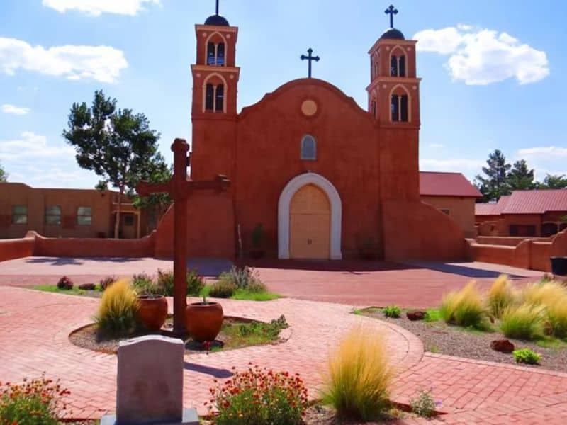 A photograph of the San Miguel Mission, an adobe building featured on the New Mexico Tourism Department website.