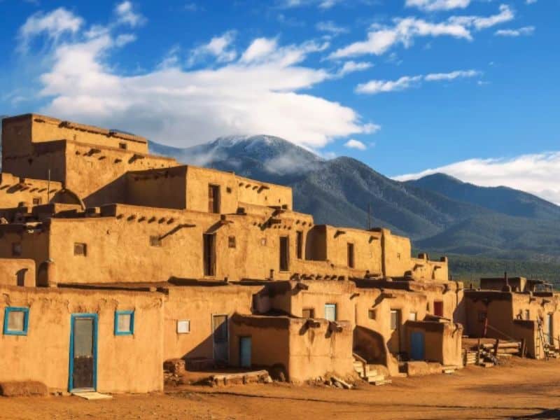 A photograph of the Taos Pueblo adobe building.