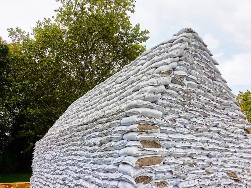 A house made from earthbags, also known as sandbags. Each course of bags overlaps the previous one for stability.