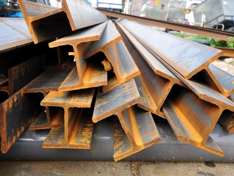 A pile of mild steel girders was collected from a demolition site. They are rusty but appear structurally sound.