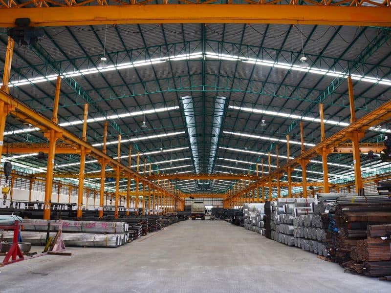 Reclaimed, salvaged steel is stored under cover in a large warehouse to protect it from the elements, prevent corrosion and avoid contamination.