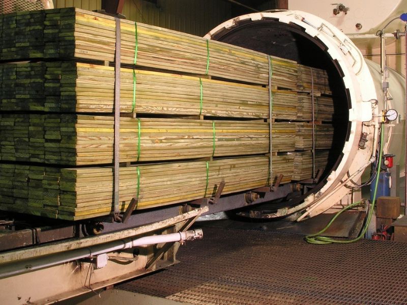 Wood is loaded into a pressure vessel for pressure treatment in a factory.